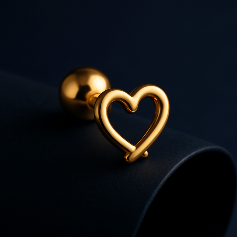 Gold heart-shaped earring on a dark background