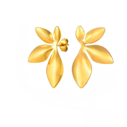 Pair of gold flower-shaped earrings on a white background