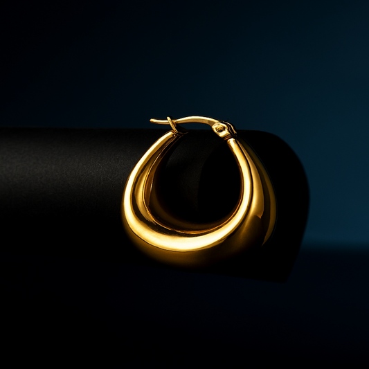 Gold hoop earring on a dark background