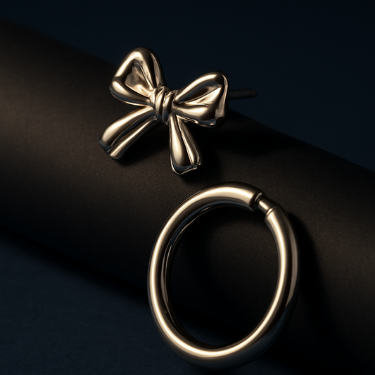 Gold bow-shaped earring on a dark background