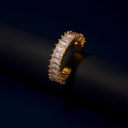 Gold ring with diamonds on a dark background