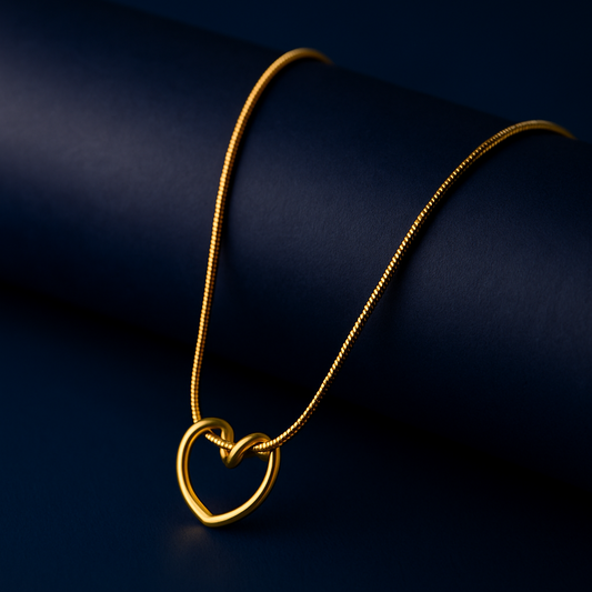 "Prism Heart Pendant Necklace in 18K PVD gold plated stainless steel on dark cylindrical surface with navy background"
