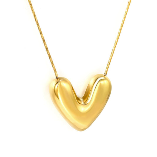 "Luna Bold Heart Necklace in 18K PVD gold plated stainless steel on white background"