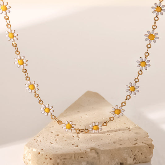 "Solara Daisy Charm Necklace with enamel flowers in 18K PVD gold plated stainless steel on light background"