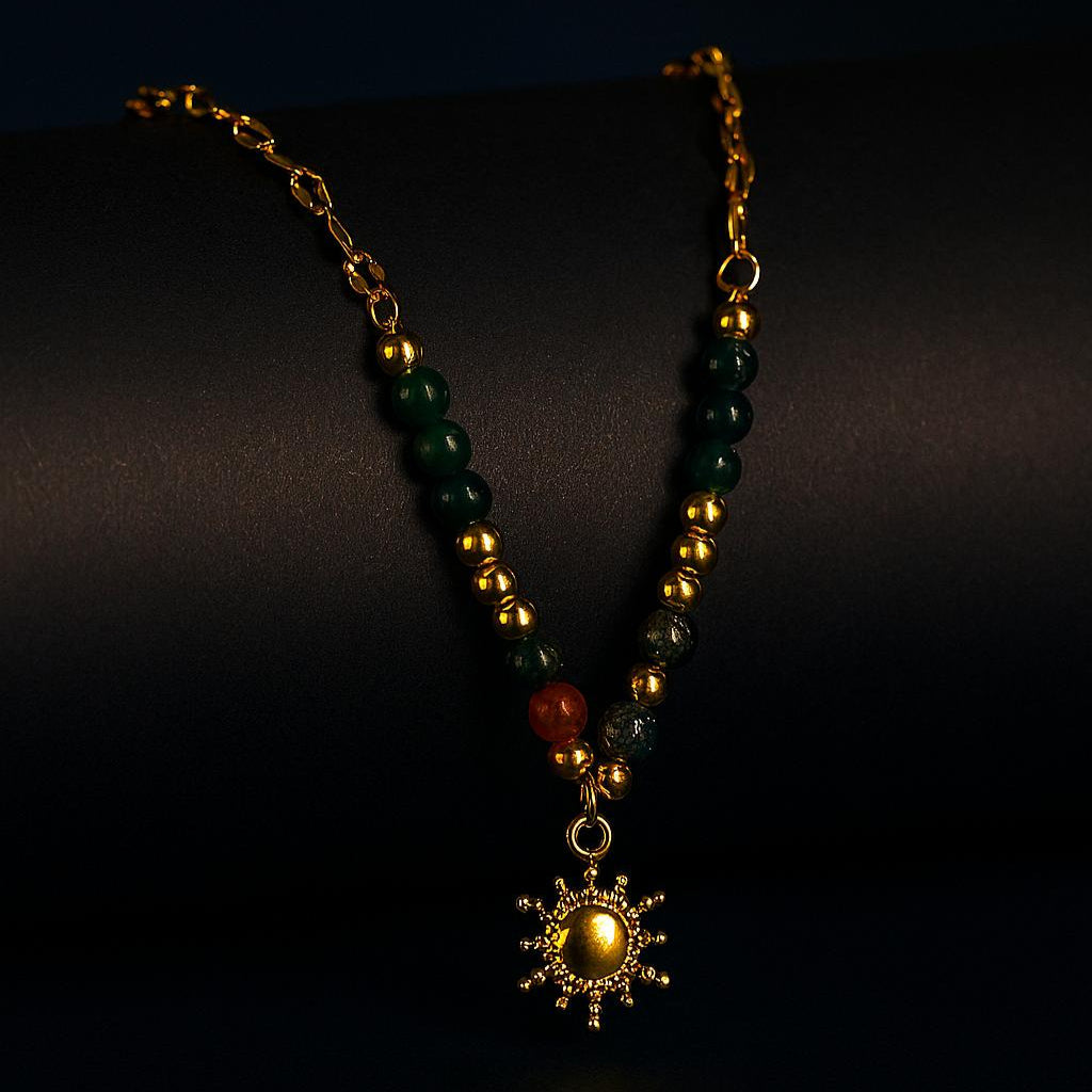 Necklace with green and gold beads and a star-shaped pendant on a dark background