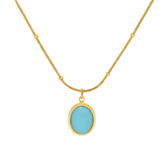 "Aurora Necklace with oval blue stone pendant in 18K PVD gold plated stainless steel on white background"