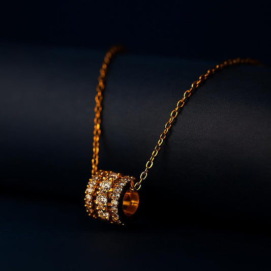  EVALINA Gold Necklace with cubic zirconia barrel pendant – dark display background