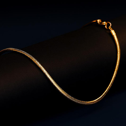 VELARA Gold Necklace flat snake chain – dark display background