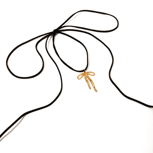 SAVINA Gold Necklace with bow pendant on black rope – white background

