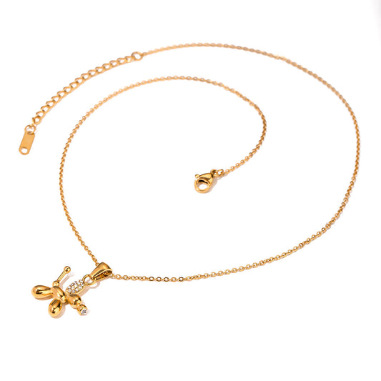 18K PVD gold plated balloon dog pendant with crystals on chain, flat lay view