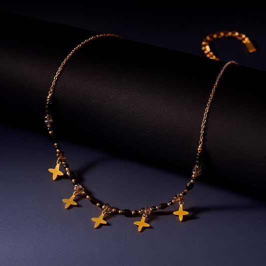 18K PVD Gold Plated Stainless Steel with Black Crystal Beads and Star Charms on dark background