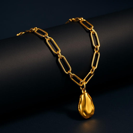 Juno Gold Necklace displayed on black cylinder, bold link chain with hammered pendant in 18K PVD gold plating