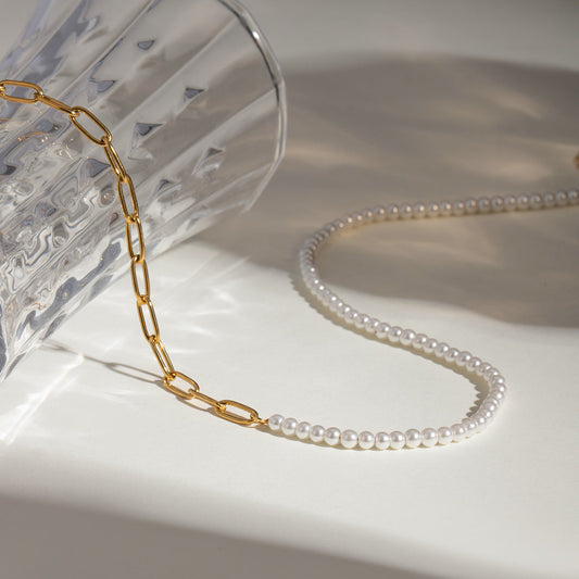 ISLE Gold Necklace with half pearl strand and half gold chain on a light background