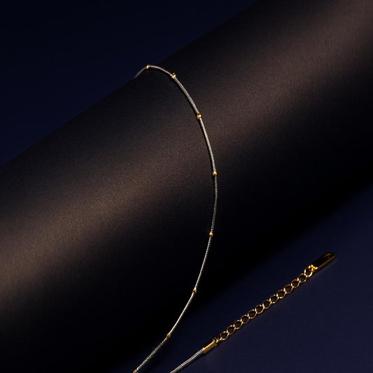 Gold necklace on a dark background