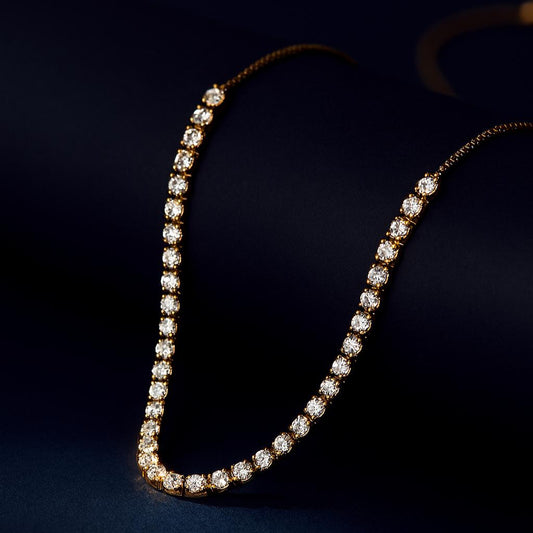 Breeze Gold Necklace – gold beaded snake chain displayed on black matte roll with navy backdropbackdrop