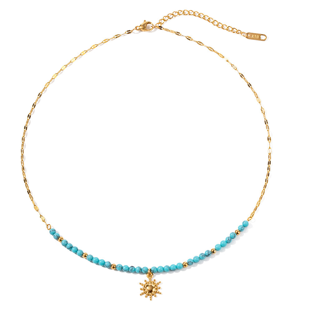 Gala Gold Necklace – turquoise beaded chain with gold sun pendant on white background