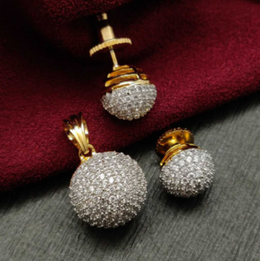 Micro Setting AD Pendant Golden Set with matching earrings – gold-plated brass with micro-set American diamonds on red fabric background