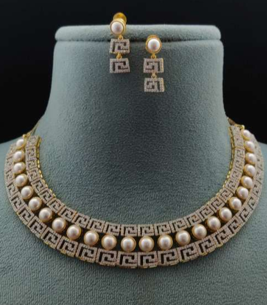 Fiamma Pura pearl and CZ designer necklace on green velvet bust with matching earrings