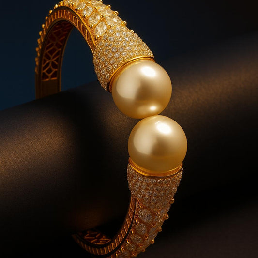 Editorial shot on black background – glowing gold AD bangle with pearls