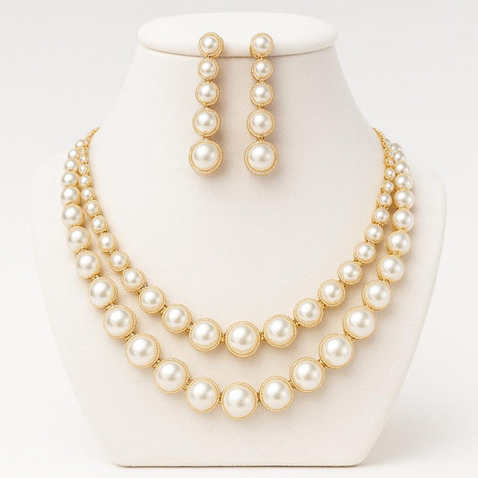 Sole Dorato gold pearl necklace set displayed on white bust with symmetrical design