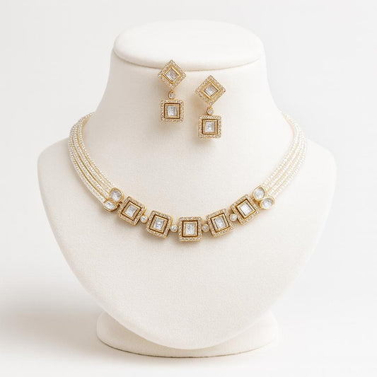 Dolce gold pearl kundan necklace set displayed on white bust with symmetrical alignment