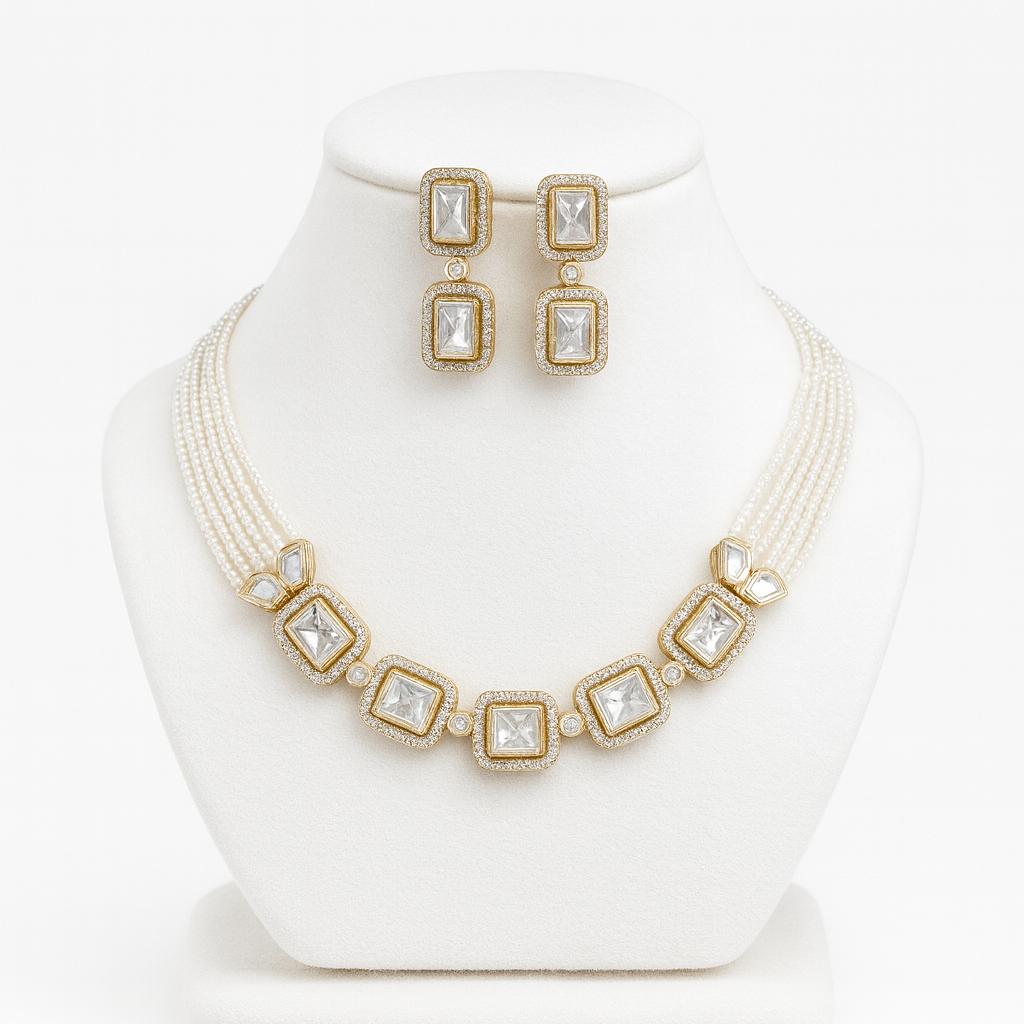 Amore kundan and pearl choker set on white bust with gold detailing and matching earrings