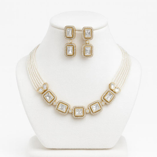 Amore kundan and pearl choker set on white bust with gold detailing and matching earrings