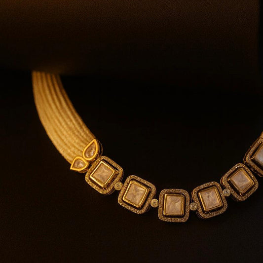  Amore pearl kundan set flat-laid on black background with elegant lighting showcasing stone detail