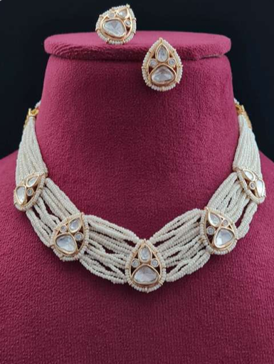 Bianca pearl kundan necklace on maroon velvet bust with earrings