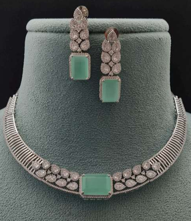 Mint green AD necklace set displayed on green velvet stand