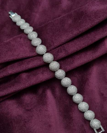 Silver-finished bracelet with round domed links, micro-set with American diamond-style CZ stones. Elegant fashion jewelry piece by Lavish Jewels.