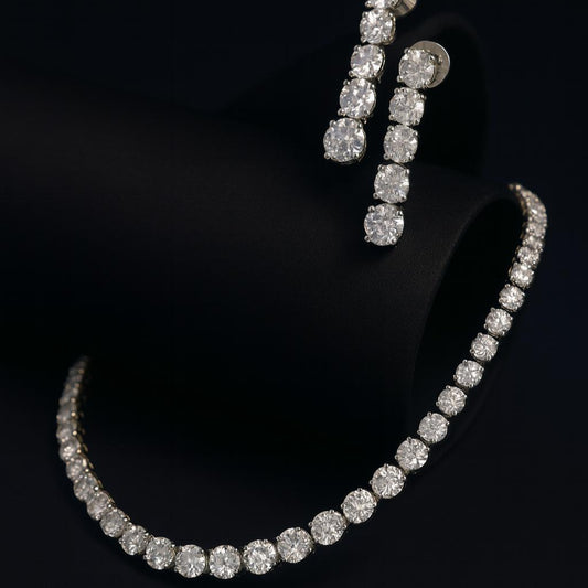Editorial black background shot of CZ necklace and earrings with dramatic lighting